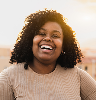 Woman smiling happily outside
